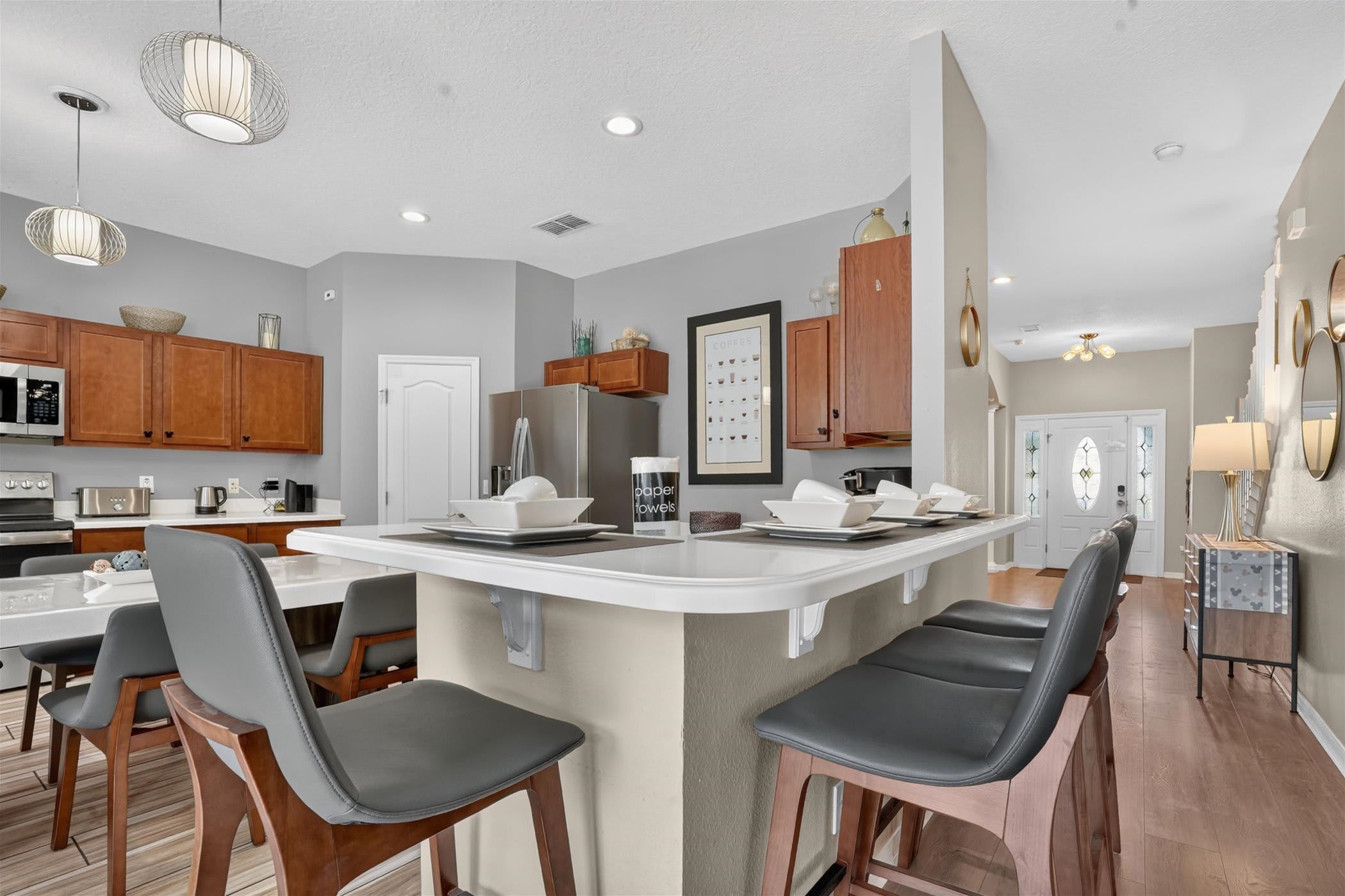 A spacious kitchen with a large island and comfortable bar seating.