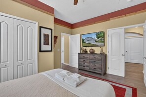 A welcoming queen bedroom with plenty of storage and natural light. - Disney-Themed Villa with Heated Pool & Playroom (Davenport)