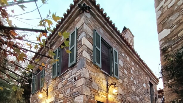 A stone building with a fire pit in the foreground. - Pulinda Pansiyon (Soke)