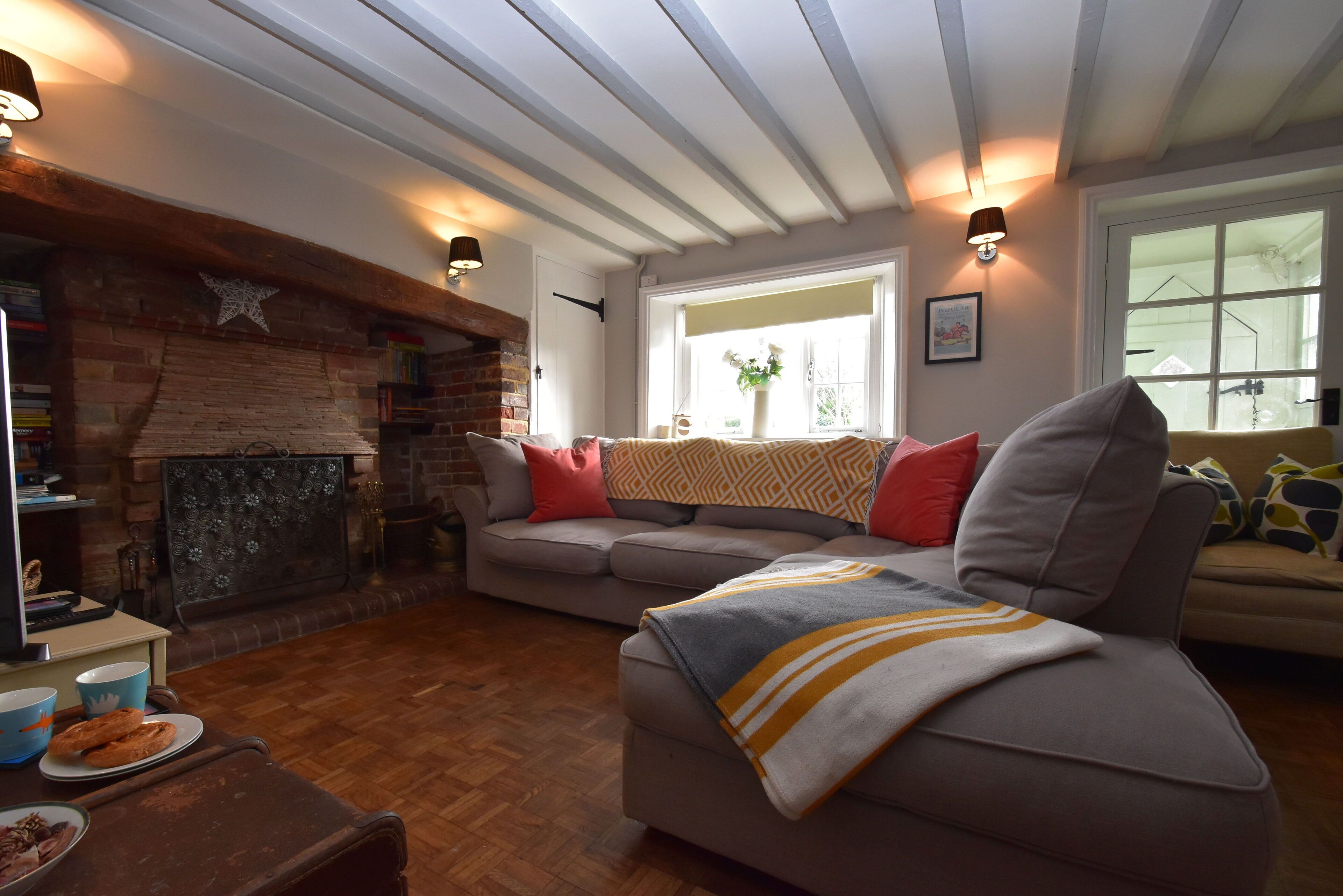 A cozy living room with a fireplace, a sofa, and a coffee table.