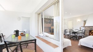 A dining area with a glass table and chairs, a coffee maker, and a breakfast setting. - 1PAN 01 - Basic house divided into 3 independent apartments located a few meters from the beautiful beach of Llafranc (Llafranc)
