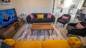 A living room with a sofa, armchairs, a coffee table, and a TV. - Inviting 4-Bed Villa Nil Dalyan with child pool (Ortaca)