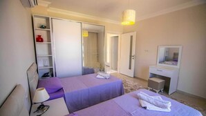 A hotel room with two beds, a desk, a mirror, and a wardrobe. - Inviting 4-Bed Villa Nil Dalyan with child pool (Ortaca)