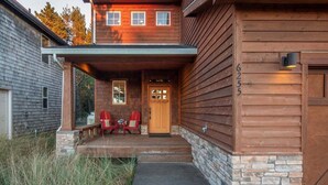 A wooden cabin with a stone foundation, a porch with two Adirondack chairs, and a door labeled "Sew Room". - Sea Jay-hot tub, 2 blocks to beach, borders forest (Pacific City)
