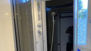 Shower, hair dryer, towels, toilet paper