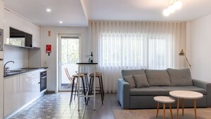A modern kitchen with a built-in oven and a dining area with a table and chairs.