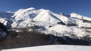 A snow-covered mountain with a clear sky.