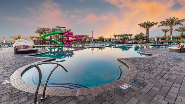 A swimming pool with a slide, lounge chairs, and palm trees. - ⭐⭐⭐⭐⭐ ⭐Heated Pool & Spa, Gourmet Kitchen, Game Room, Fire Table & BBQ Island  (Mesa)