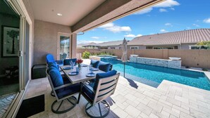 A patio with a pool, outdoor seating, and a view of neighboring houses. - ⭐⭐⭐⭐⭐ ⭐Heated Pool & Spa, Gourmet Kitchen, Game Room, Fire Table & BBQ Island  (Mesa)