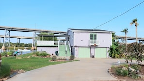 A two-story house with a green staircase, a covered porch, and a garage.