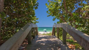 A wooden pathway leading to a beach with a clear view of the ocean. - ⭐ NEW! Starfish Wishes | Saltwater Pool & Spa • Walk to Beach • Sleeps 9 (Naples)