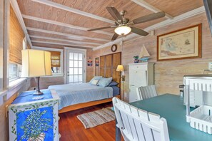 A bedroom with a bed, a desk, a chair, a ceiling fan, and a window. - Hidden Treasure in Old Town: 3BR Home with Pool in Peaceful Gated Enclave (Key West)