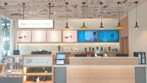 A coffee shop interior with a counter, menu boards, and hanging lights. - Huamei Hotel (Linyi Luozhuang District Government) (Linyi)