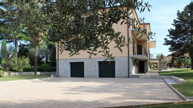 A two-story building with a paved driveway and a small garden area. - Apartment Casa Monte Mulini 1/1 (Rovinj)