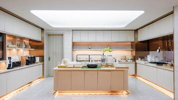 A modern kitchen with a central island, built-in appliances, and a skylight.