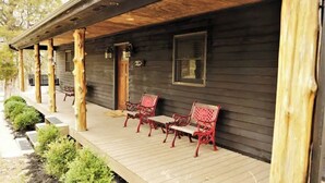 A wooden porch with a bench and a door. - Tranquil Cabin on Barren River Lake (Glasgow)