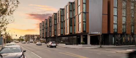 A modern building with a flat facade, large windows, and a sign reading 'CAMBRIA'.
