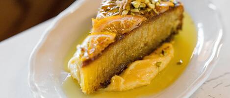 A dessert on a white plate with a glossy sauce.