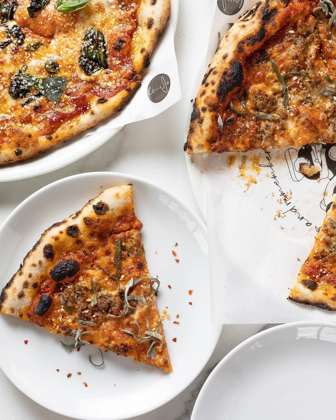 A pizza with visible toppings and a slice missing.