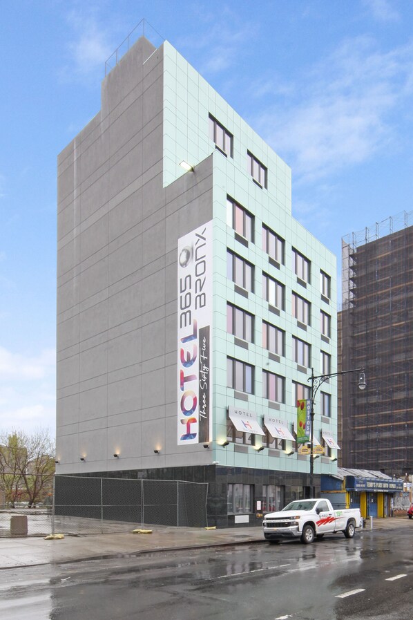 A hotel with multiple floors, a modern design, and a visible sign for 'HOTEL 365 BROX'.