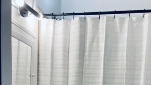 A bathroom with a toilet, sink, and shower curtain. - Walkable to Huntington Center, Fifth-Third Field and the Convention Center! (Toledo)