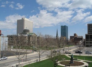 A cityscape with a prominent building with a dome, a tall skyscraper, and a modern glass building. - Downtown Toledo King Studio | Library Square D (Toledo)