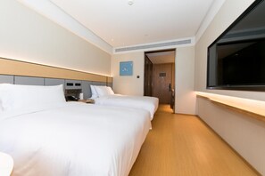 A hotel room with two beds, a bedside table with a phone and a cup, a large window, and a door leading to another room. - Ji Hotel (Dezhou)