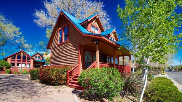 A wooden house with a blue roof, a porch, and a small garden. - *BBQ *Pet Friendly *WIFI *Walk to Whiskey Row (Prescott)