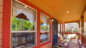 A covered porch with large windows, a wooden ceiling, and a view of trees. - *BBQ *Pet Friendly *WIFI *Walk to Whiskey Row (Prescott)