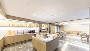 A modern kitchen with marble flooring, wooden cabinets, and a central island with various kitchen items. - Ji Hotel (Taiyuan)