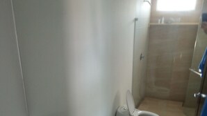 A bathroom with a white sink, a toilet, and a shower. - apartment- suits 1 to 14 people (Cartagena)