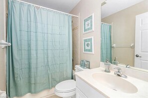Bathtub, hair dryer, towels, toilet paper