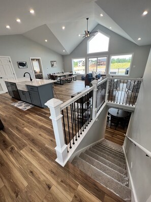 Enjoy meals and gatherings in the central kitchen and dining area, featuring a large island and ample counter space.