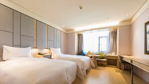 A hotel room with two beds, a desk, a chair, and a window with curtains. - Ji Hotel (Taiyuan)