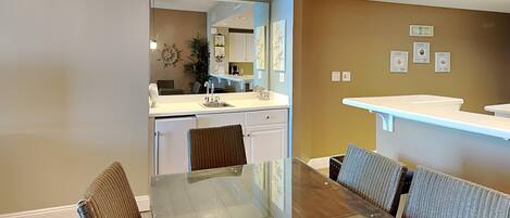A modern kitchen with a dining area.