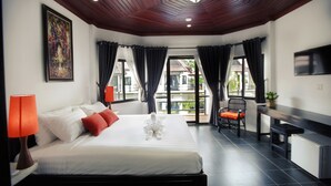 A hotel room with a bed, a desk, a chair, a TV, and a balcony with curtains. - Sekla Villa Angkor (Siem Reap)