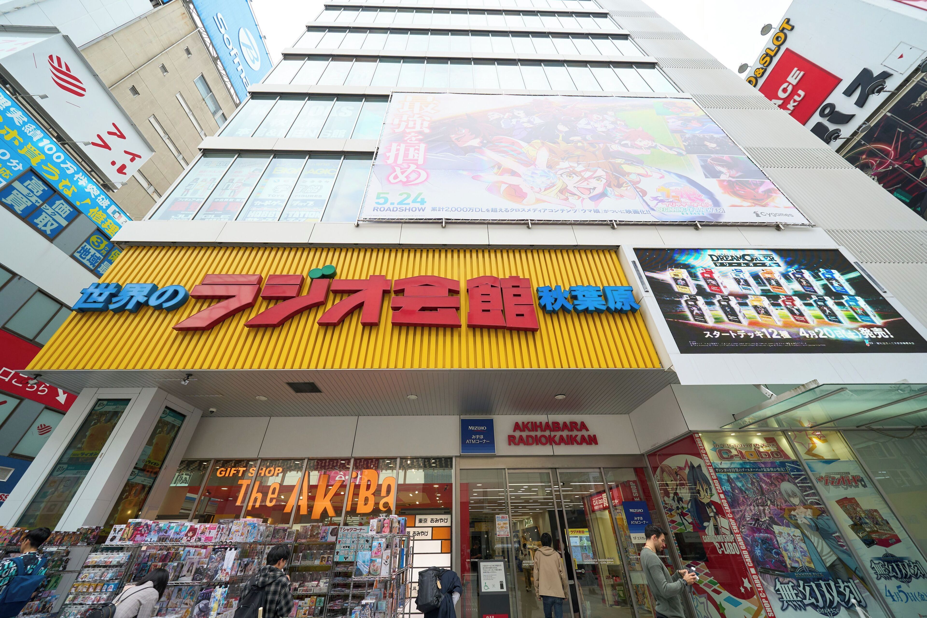 A shopping arcade with various stores, including a gift shop and a manga bookstore.