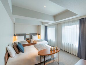 A hotel room with a large bed, bedside tables, a round table, and a view of the outdoors through sheer curtains. - Hotel Resol Stay Akihabara (Tokyo)