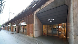 A building with a modern facade, featuring a prominent 'MAACH' sign.