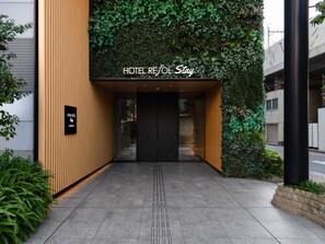 A hotel entrance with a sign reading 'HOTEL REJOL Stay' and a black sign below it. - Hotel Resol Stay Akihabara (Tokyo)