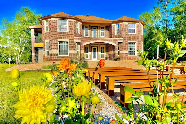 Beautiful flower gardens make the yard bright all year around.
