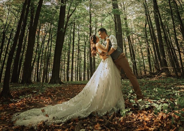 A forest setting with a bride and groom embracing. - ROSA VILLA - Wedding & Retreat Resort-12 acres, 21 beds & host 200+ppl event (Cleveland)