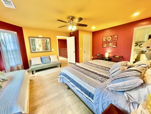 A bedroom with a bed, a sofa, a ceiling fan, and a painting on the wall. - ROSA VILLA - Wedding & Retreat Resort-12 acres, 21 beds & host 200+ppl event (Cleveland)