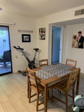 Enjoy meals with family and friends in this cozy dining area, complete with a table for four and comfortable seating.