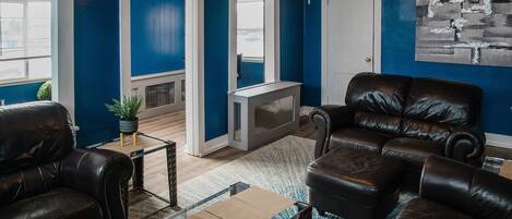 Relax in this inviting living space with a comfortable sofa, coffee table, and potted plant.