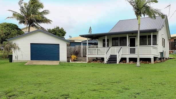 A two-story house with a covered porch and a garage.