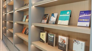 A library with bookshelves containing various books. - Ji Hotel Shanghai People's Square Beijing West Roa (Shanghai)