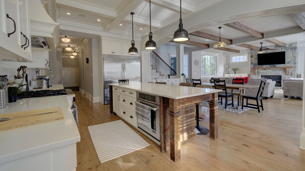 A spacious kitchen with a large island, wooden beams, and pendant lighting. - 9 bdrm home, sleeps 26 w/ hot tub/gym/theatre/bar (Surrey)