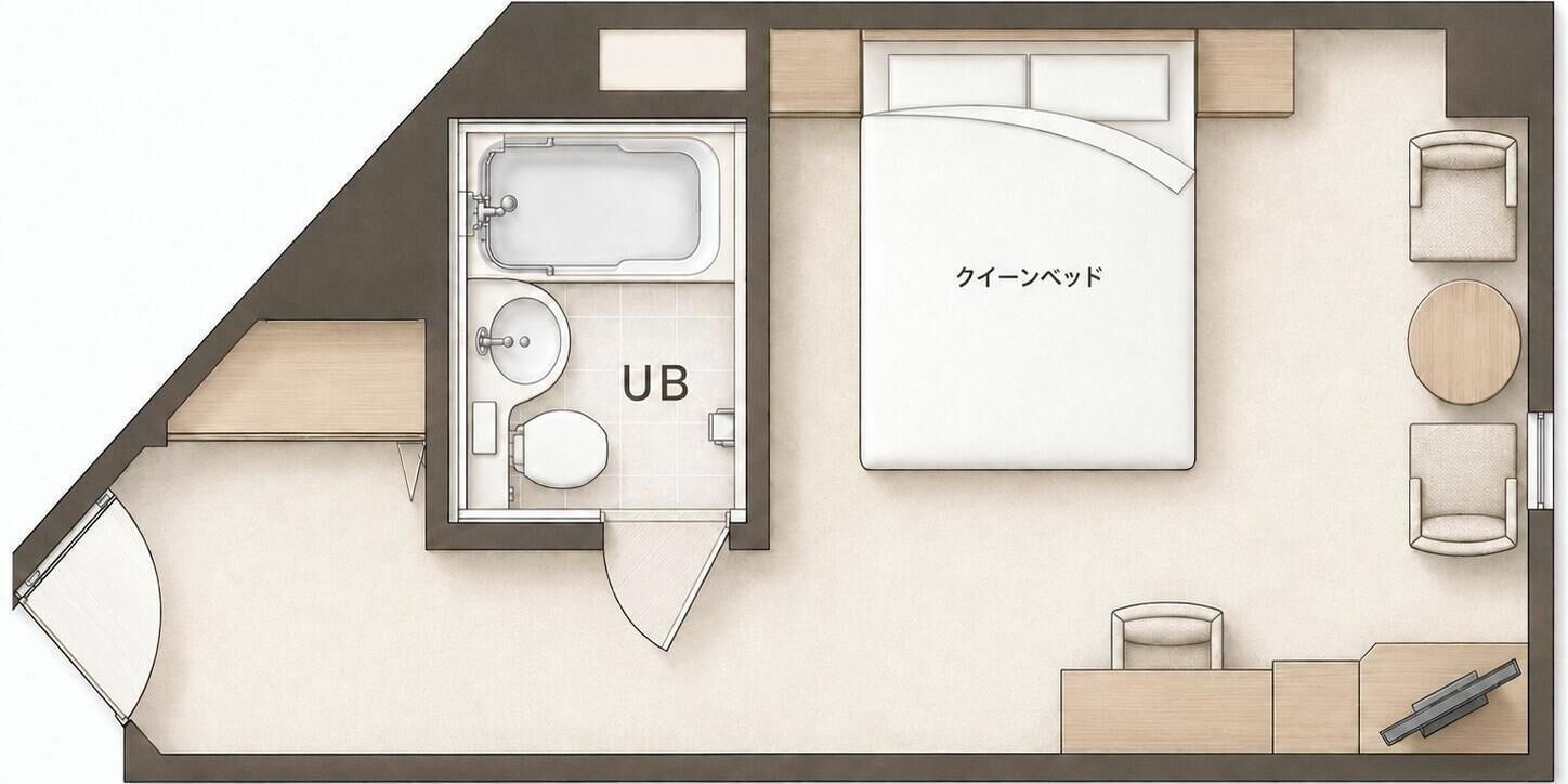 Distribución de una habitación de hotel con cama, baño, zona de estar y una mesita.