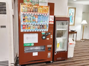 A vending machine with various beverages and a La Jolie Motomachi sign. - La Jolie Motomachi (Hakodate)